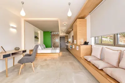 a living room with a bed and a couch at Lilium Luxury Suites in Agia Marina Nea Kydonias