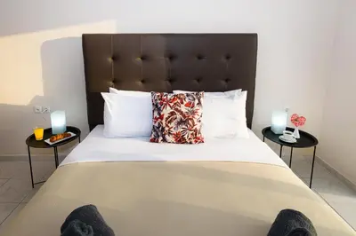 a bedroom with a large bed with two side tables at Room 25 in Chania Town