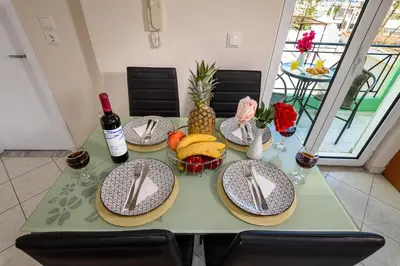 a table with plates of food and a bottle of wine at Room 25 in Chania Town