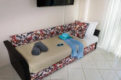 a couch with pillows on it in a living room at Room 25 in Chania Town