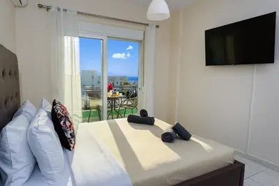 a bedroom with a large bed with a large window at Room 25 in Chania Town