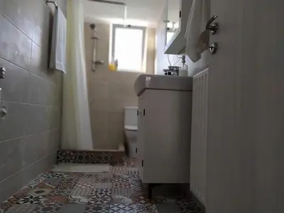 a small bathroom with a sink and a toilet at Sunday Apartment Chania 2B in Chania Town