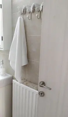 a bathroom with a shower with a towel and a towel rack at Sunday Apartment Chania 2B in Chania Town