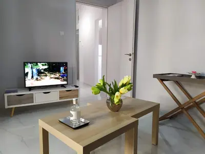 a living room with a vase of flowers on a table at Sunday Apartment Chania 2B in Chania Town