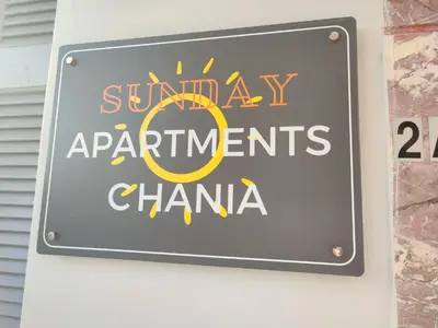 a sign for the sunray apartments chania on a building at Sunday Apartment Chania 2B in Chania Town