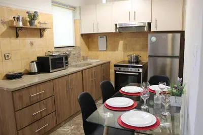 a kitchen with a dining table with red and white plates at Chania Nice Apartment in Chania Town