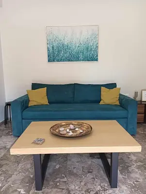 a blue couch in a living room with a coffee table at Chania Nice Apartment in Chania Town