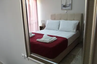 a mirror reflection of a bed in a bedroom at Chania Nice Apartment in Chania Town