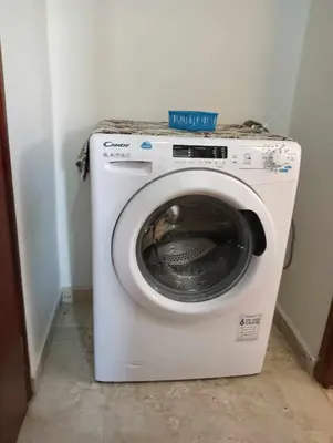 a white washing machine sitting in a room at Chania Nice Apartment in Chania Town