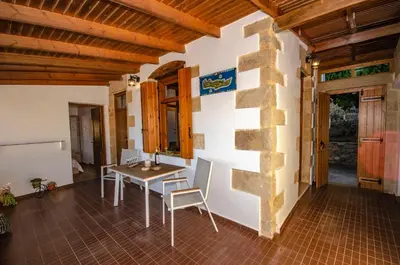 a room with a table and chairs in a house at Trouli Rokka House in Kissamos