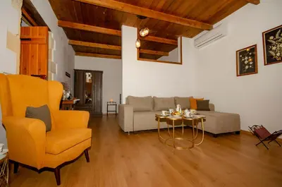 a living room with a couch and a table and chairs at Trouli Rokka House in Kissamos