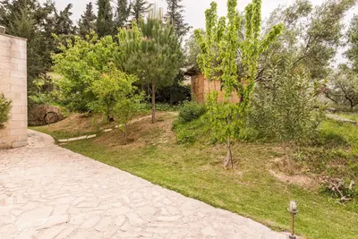 a garden with trees and a brick path at Villa Aloni in Fílippos