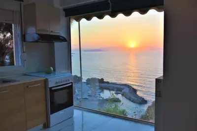 a kitchen with a view of the ocean at Emerald Apartment Halepa in Chania Town