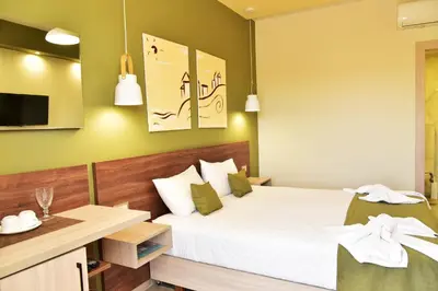 a bedroom with a large bed and a desk at Lafo Rooms in Elafonisi