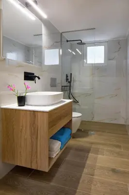 a bathroom with a tub and a sink and a shower at s u e ñ o - studios and apartments, with shared pool in Kato Daratso