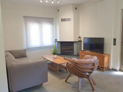 a living room with a couch and a tv at Four Seasons Homes in Stalos