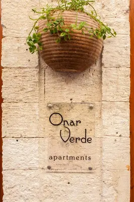 a plant in a basket hanging on a wall at Charming Studio in the Old Town in Chania Town