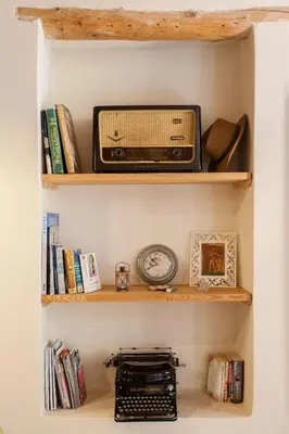 a book shelf with a radio and books at Charming Studio in the Old Town in Chania Town