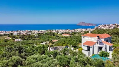 an image of a villa with the sea in the background at Venizelos Studios in Plataniás
