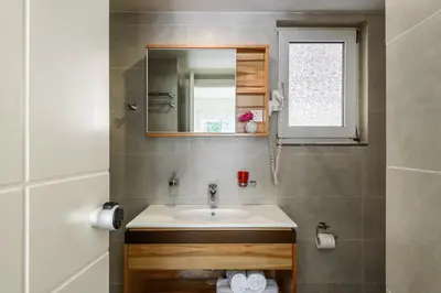 a bathroom with a sink and a mirror at Despina Apartments in Plataniás