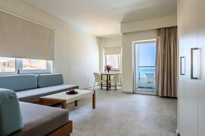 a living room with a couch and a table at Despina Apartments in Plataniás