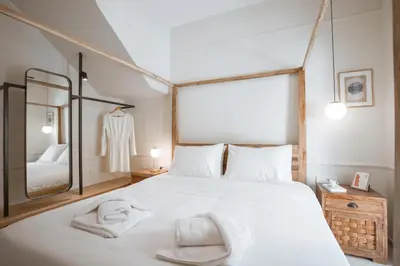 a bedroom with a large white bed with towels on it at Casa Dei Miracoli in Chania Town