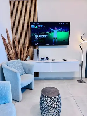 a living room with a tv on a wall at Blue Green Villa Kalyves eco pool premium quality in Kalyves