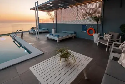 a living room with a pool and a table and a table at Blue Green Villa Kalyves eco pool premium quality in Kalyves