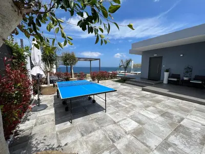 a ping pong table in the middle of a patio at Blue Green Villa Kalyves eco pool premium quality in Kalyves