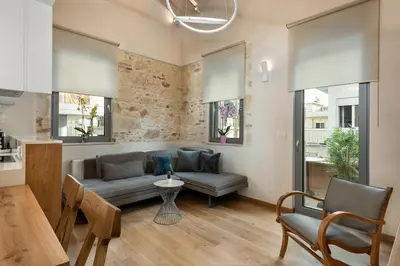 a living room with a couch and a table at Chania Escapes City Loft 50 meters by the Sea in Chania Town