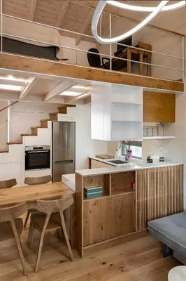 a kitchen with a wooden table and a staircase at Chania Escapes City Loft 50 meters by the Sea in Chania Town