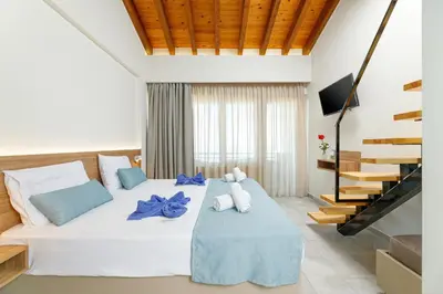 a bedroom with a bed with two teddy bears on it at Kostakis Beach in Gerani Chanion