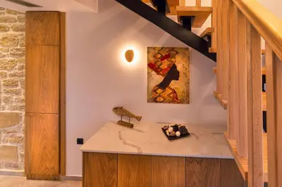 a kitchen with a counter and a painting on the wall at Athinais villa in Palaiochóra