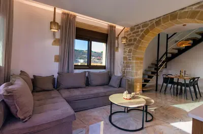 a living room with a couch and a table at Anma Villa in Palaiochóra