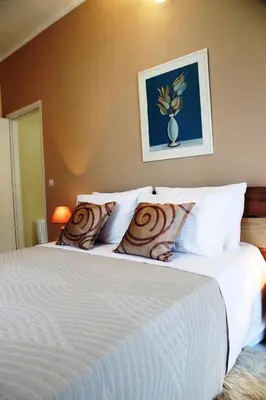 a bedroom with a bed with white sheets and pillows at Kleanthi's House in Chania Town
