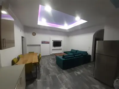 a living room with a couch and a table at Utsi in Liyidhés