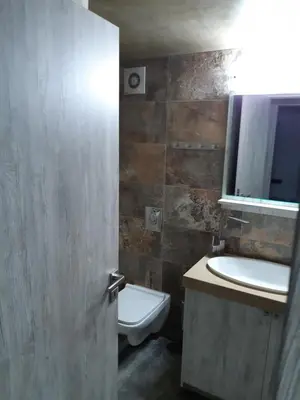 a bathroom with a sink and a toilet and a mirror at Utsi in Liyidhés