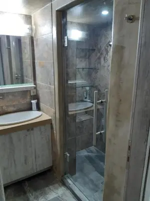a bathroom with a shower and a sink at Utsi in Liyidhés
