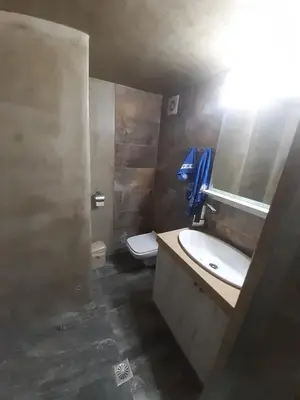 a bathroom with a sink and a toilet at Utsi in Liyidhés
