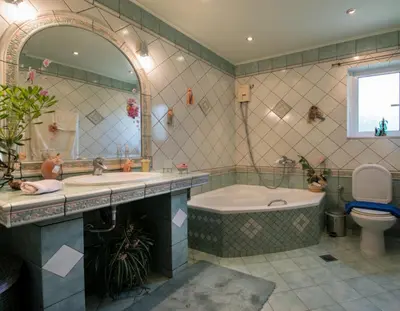 a bathroom with a tub and a toilet and a sink at Villa sotiris in Kissamos