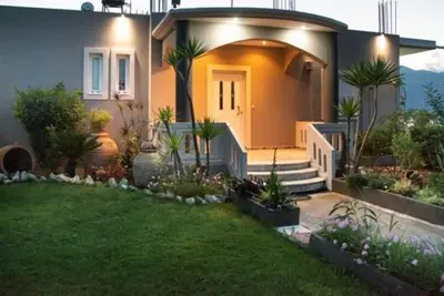 a small house with a front yard with a lawn at Villa sotiris in Kissamos