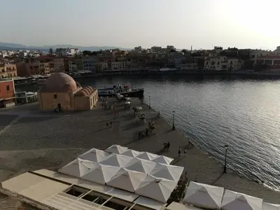 a view of a body of water with a building at Porto Chania in Chania Town