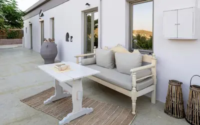 a couch and a table on a patio at M & E Kissamos sea view house in Kissamos