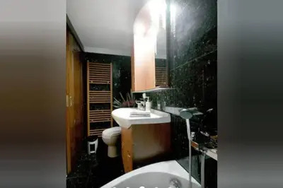 a bathroom with a white sink and a toilet at Apartment with Premium Facilities in Chania Town