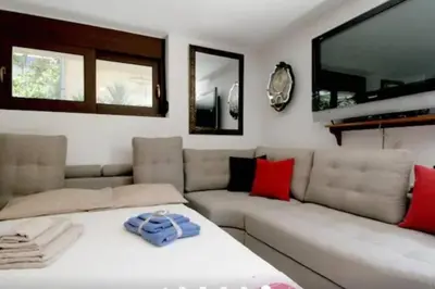 a living room with a white couch at Apartment with Premium Facilities in Chania Town