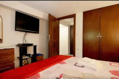 a bedroom with a bed and a flat screen tv at Apartment with Premium Facilities in Chania Town