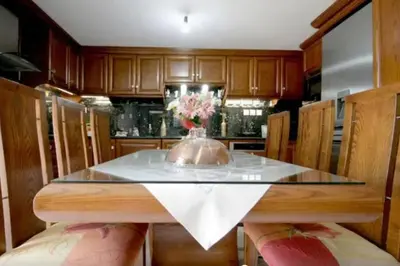 a kitchen with a table with a vase of flowers on it at Apartment with Premium Facilities in Chania Town