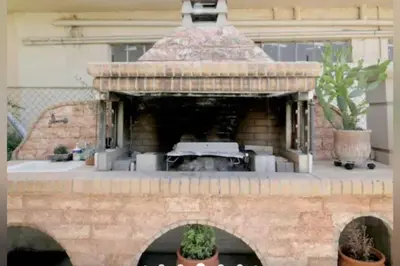 a stone pizza oven with a car inside of it at Apartment with Premium Facilities in Chania Town