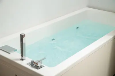 a bath tub with a sink in a bathroom at Elia Portou Luxury Residence in Chania Town
