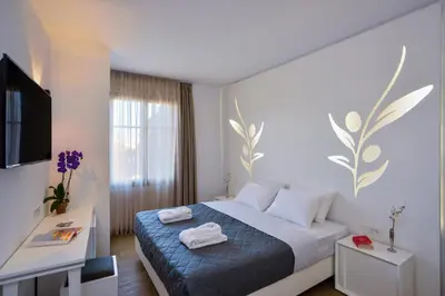 a hotel room with a bed with towels on it at Elia Portou Luxury Residence in Chania Town